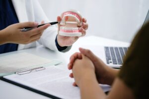 Dentist examining a patient teeth medical treatment at the dental office
