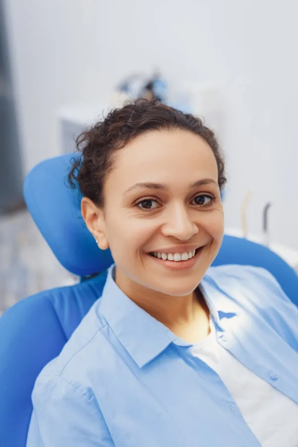 Portrait of happy lady with beautiful smile looking at camera. Smiling woman posing in dental chair