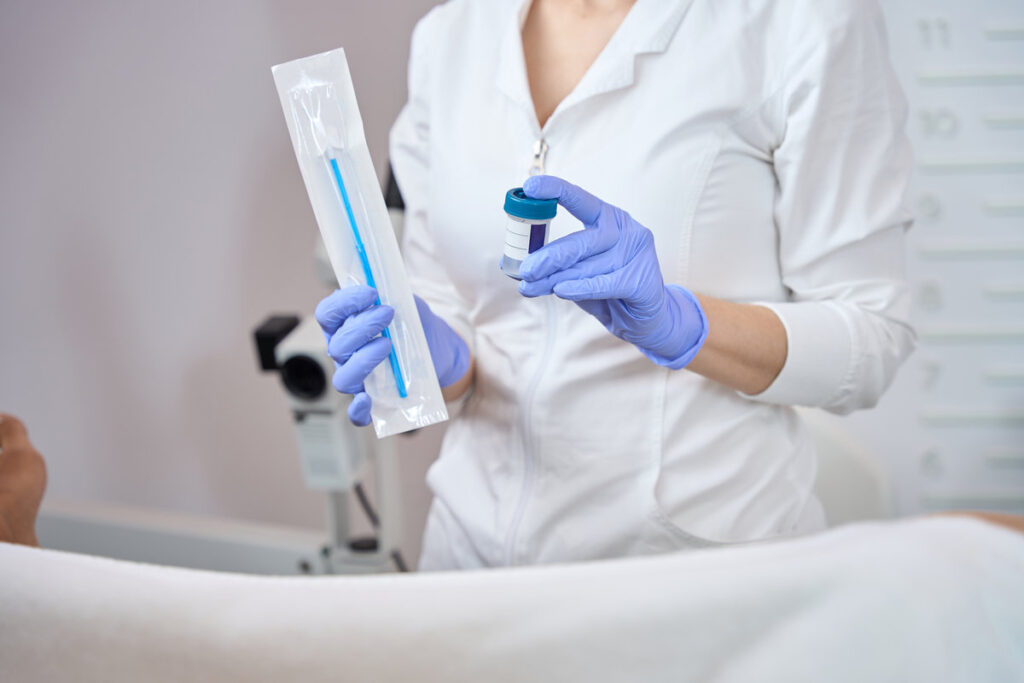 Woman gynecologist is holding in her hands a set for taking biomaterial from the vagina for analysis