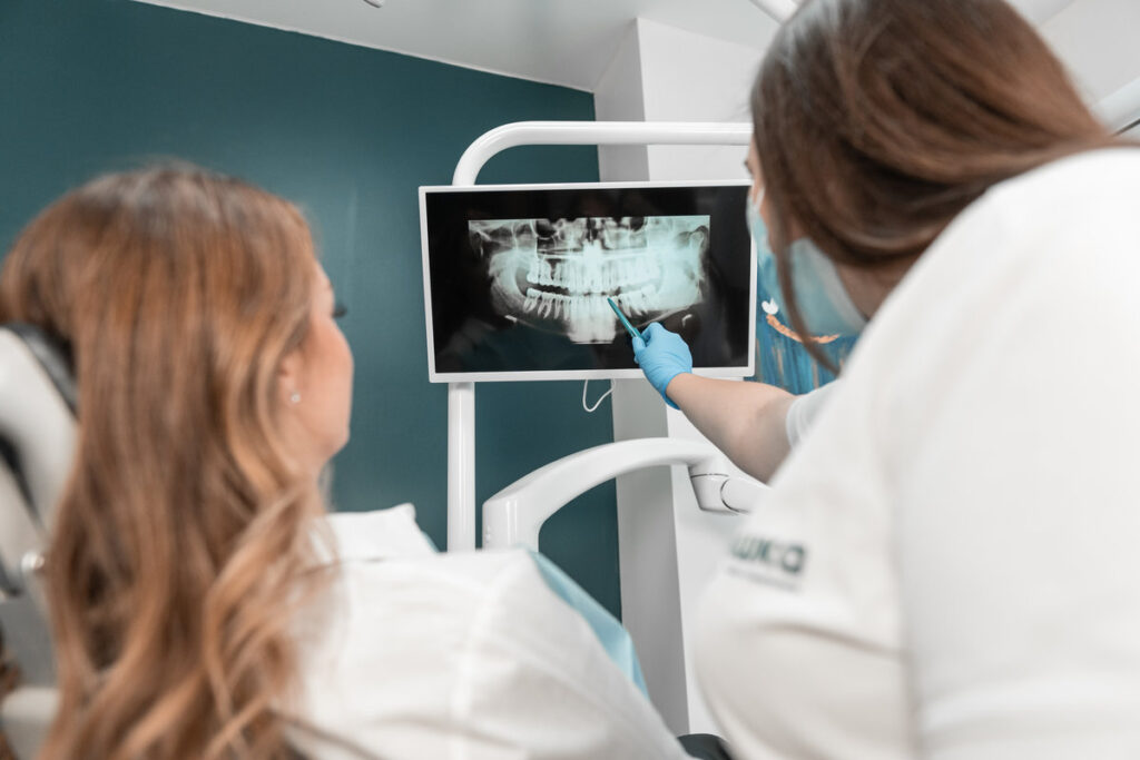 The dentist carefully analyzes the MRI image of the oral cavity in order to plan treatment. The patient receives an individual consultation from an experienced dentist based on the analysis of images. High quality photo