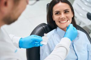 Dental technician selecting the proper shade and size of a dental crown
